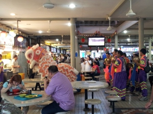 lion dancers bringing good luck to hawker center businesses